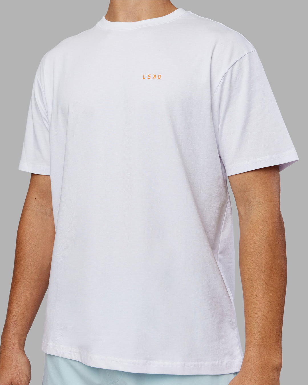 Man wearing Enjoy the Journey Value Series FLXCotton Tee Oversize - White-Vibrant Orange | Model:Jackson | Size:L
