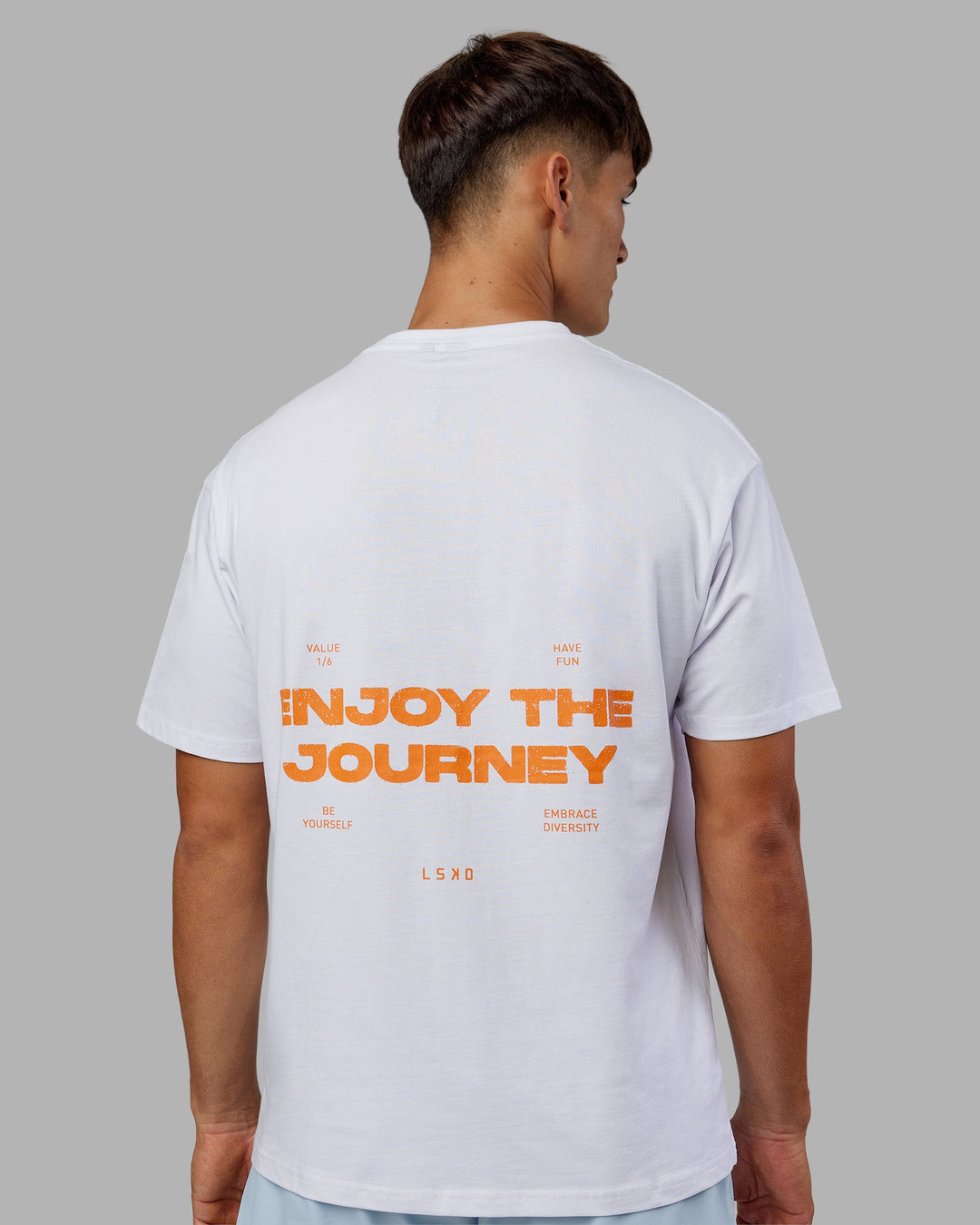 Man wearing Enjoy the Journey Value Series FLXCotton Tee Oversize - White-Vibrant Orange | Model:Jackson | Size:L
