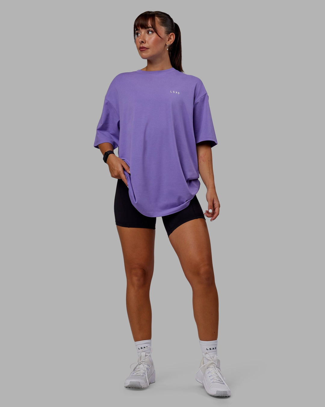 Woman wearing Unisex Lift-Up FLXCotton Tee Oversize - Dahlia Purple