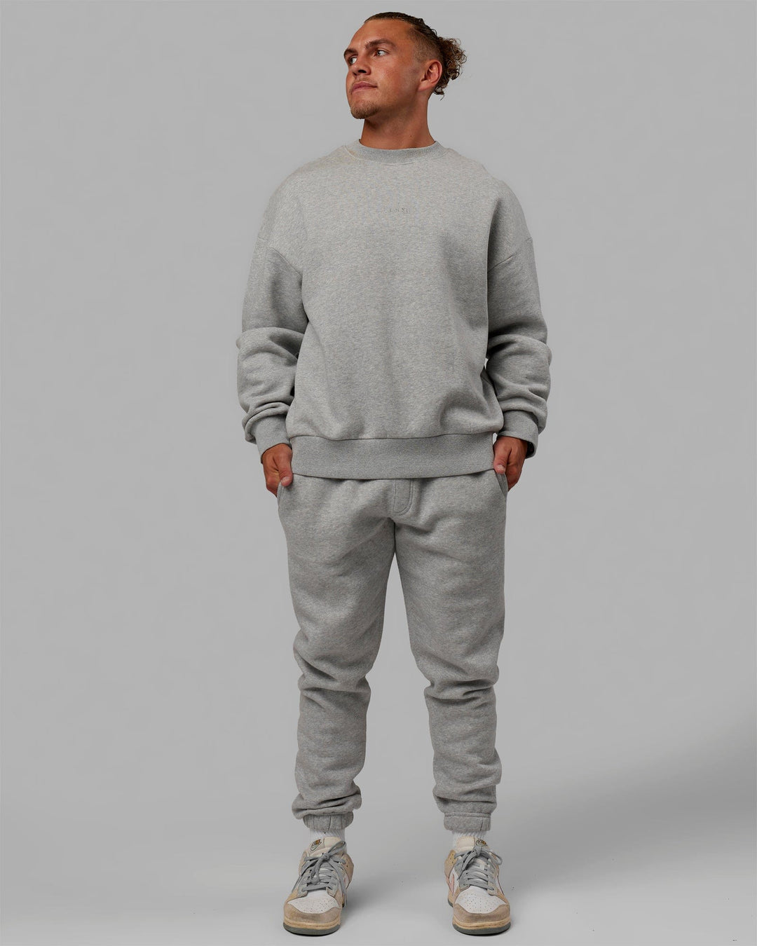 Man wearing Unisex MVP Sweater Oversize - Light Grey Marl