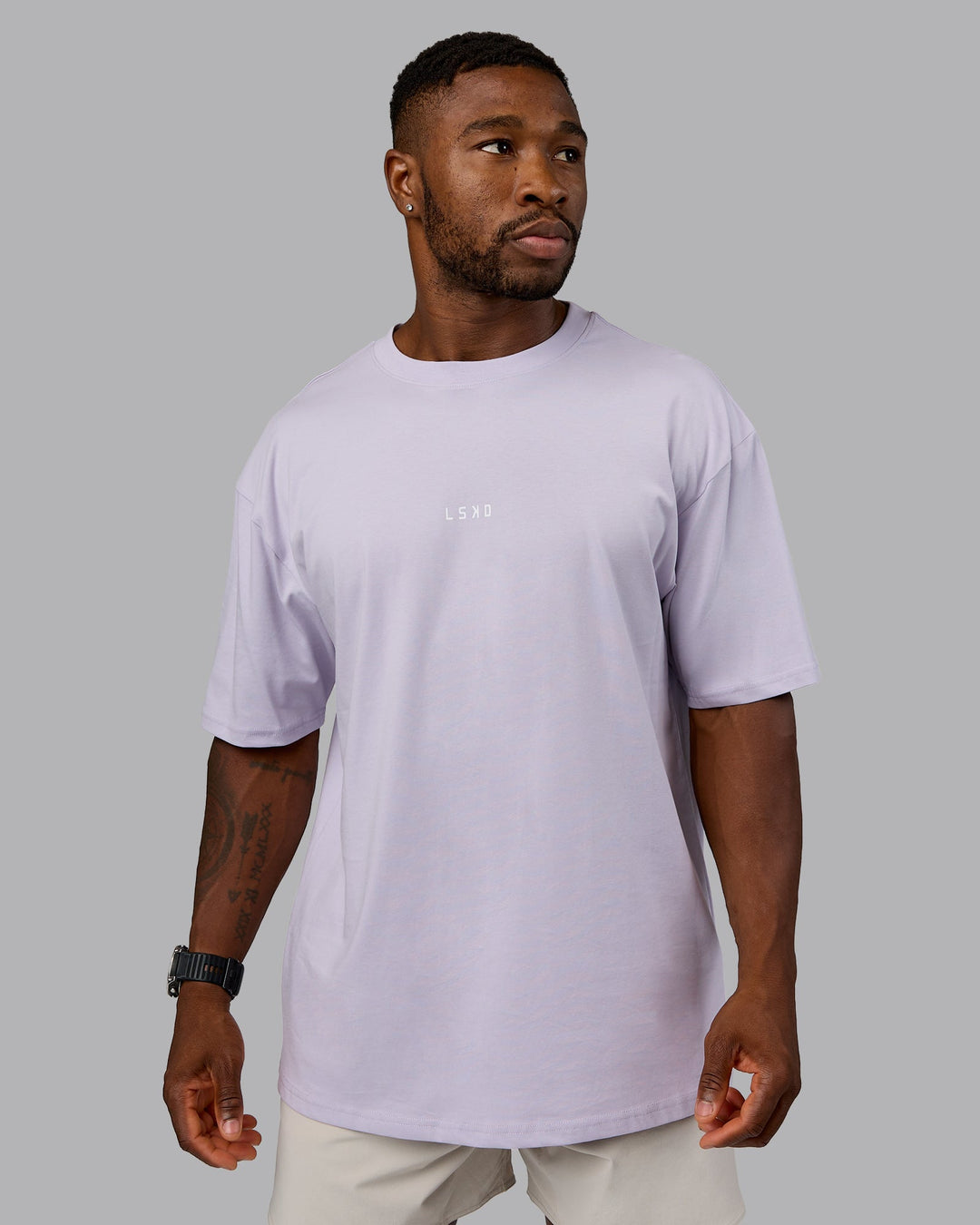 Man wearing On Repeat FLXCotton Oversized Tee - Galactic Lilac-Peach Fuzz | Model:Sam | Size:L
