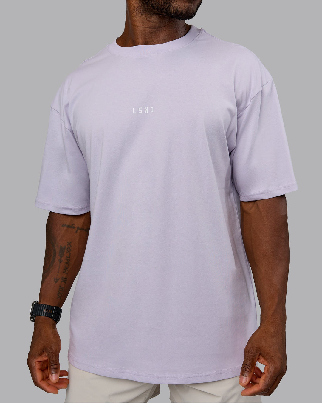 Man wearing On Repeat FLXCotton Oversized Tee - Galactic Lilac-Peach Fuzz | Model:Sam | Size:L