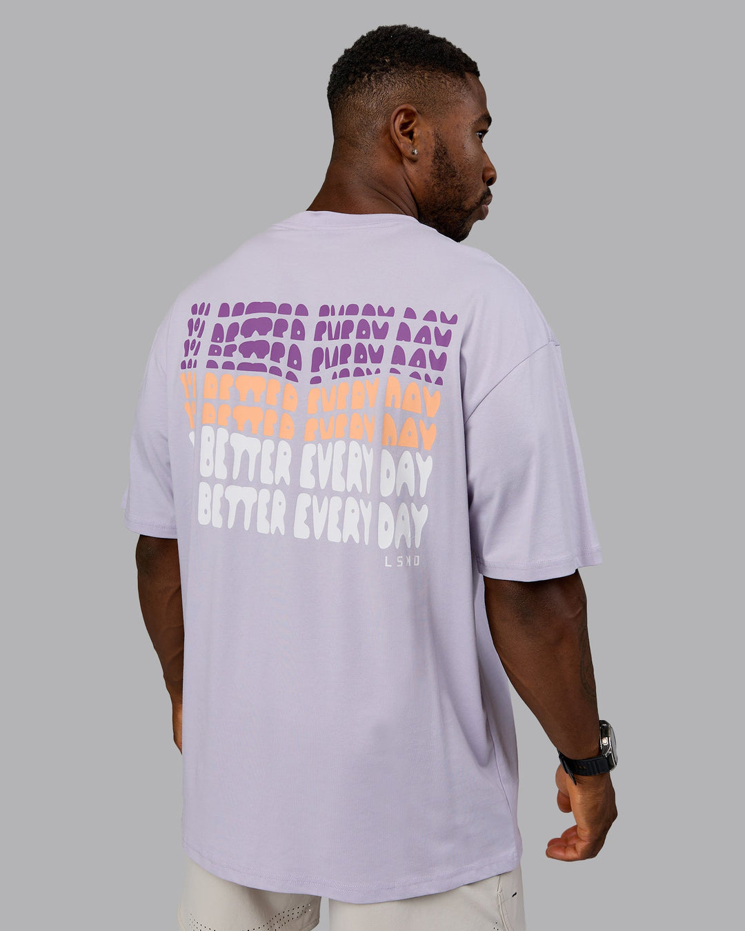 Man wearing On Repeat FLXCotton Oversized Tee - Galactic Lilac-Peach Fuzz | Model:Sam | Size:L