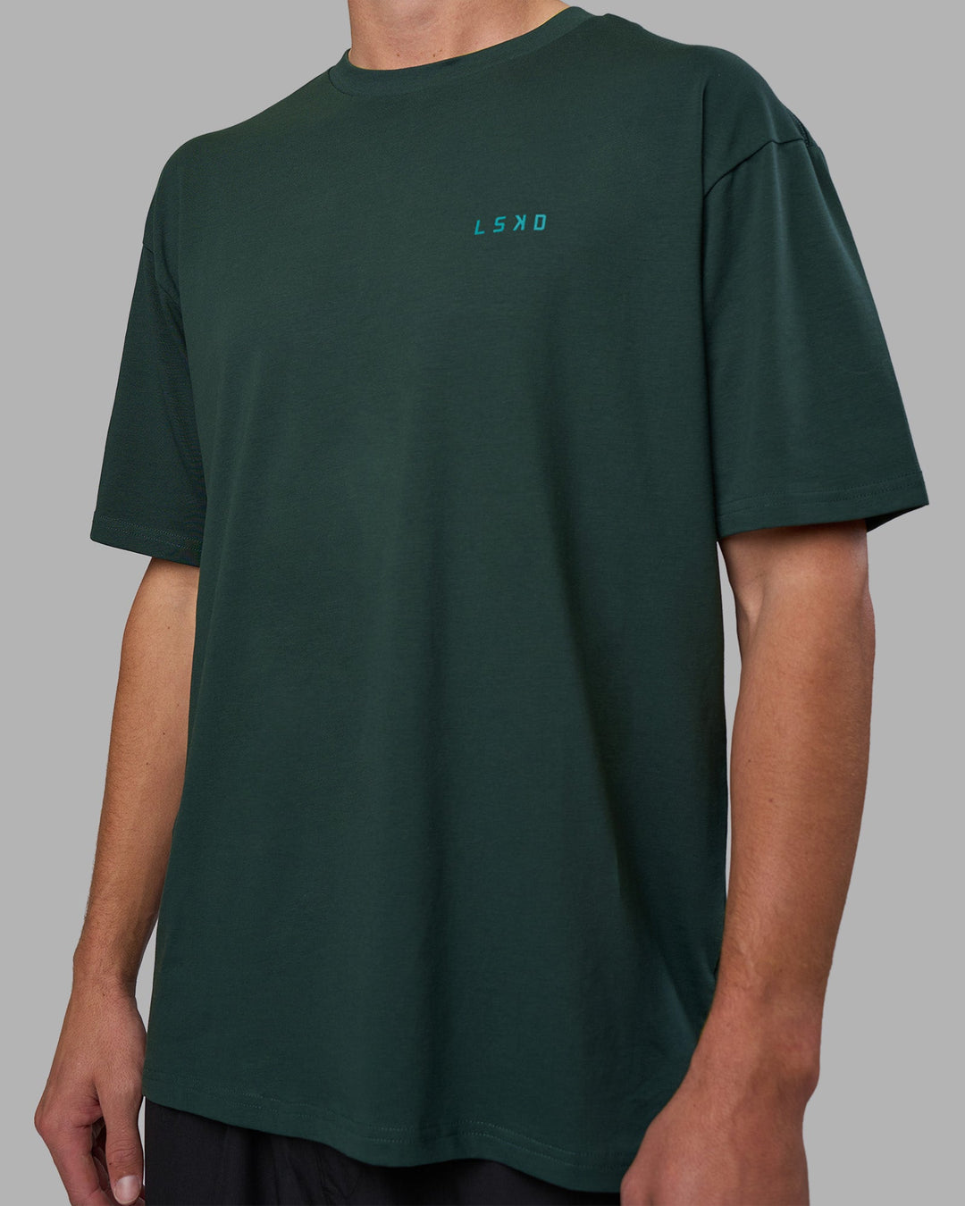Man wearing Unisex Strike Through FLXCotton Tee Oversize - Vital Green-Alexandrite | Model:Brandon | Size:L