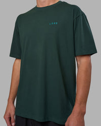 Man wearing Unisex Strike Through FLXCotton Tee Oversize - Vital Green-Alexandrite | Model:Brandon | Size:L