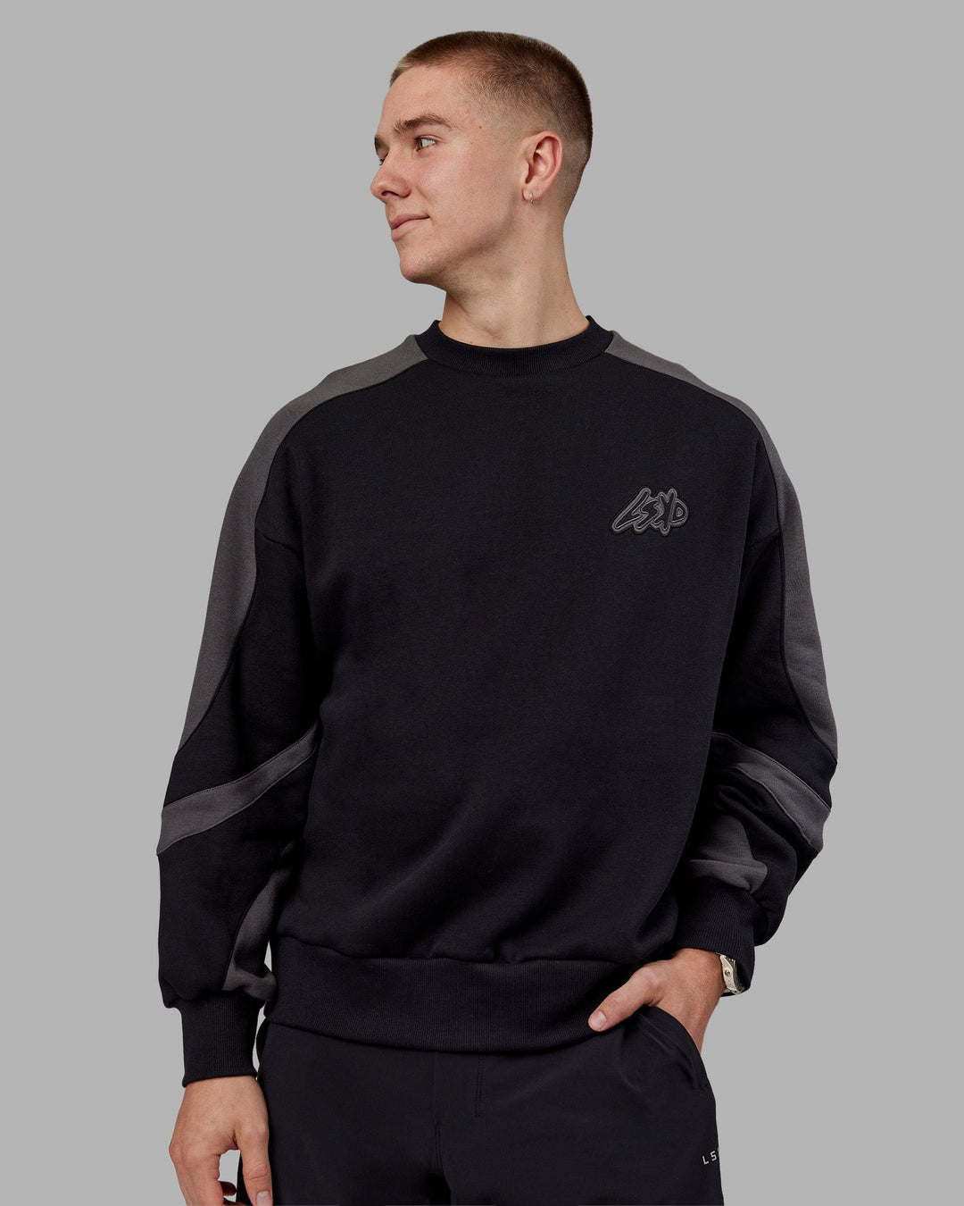 Man wearing Vibe Oversized Unisex Sweater - Black-Dark Storm | Model:Tom  Size:L