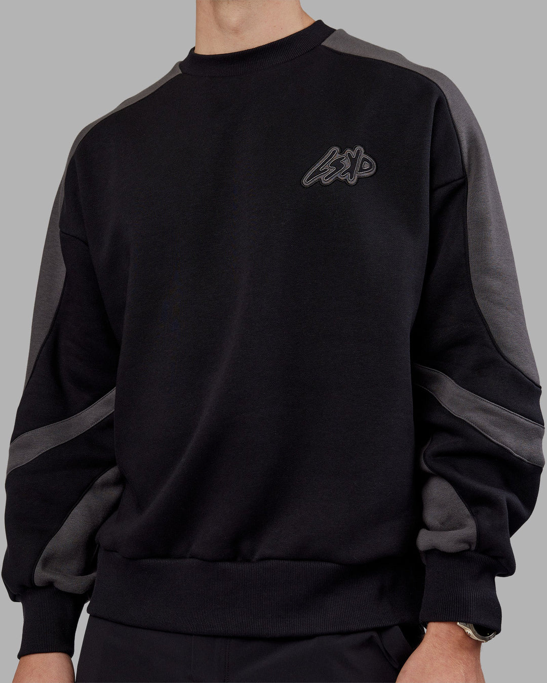 Man wearing Vibe Oversized Unisex Sweater - Black-Dark Storm | Model:Tom  Size:L