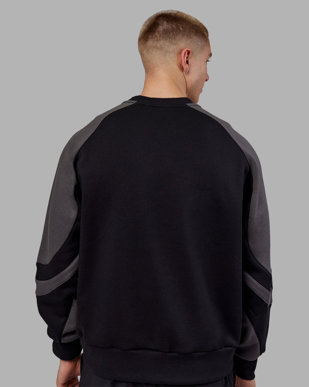 Man wearing Vibe Oversized Unisex Sweater - Black-Dark Storm | Model:Tom  Size:L