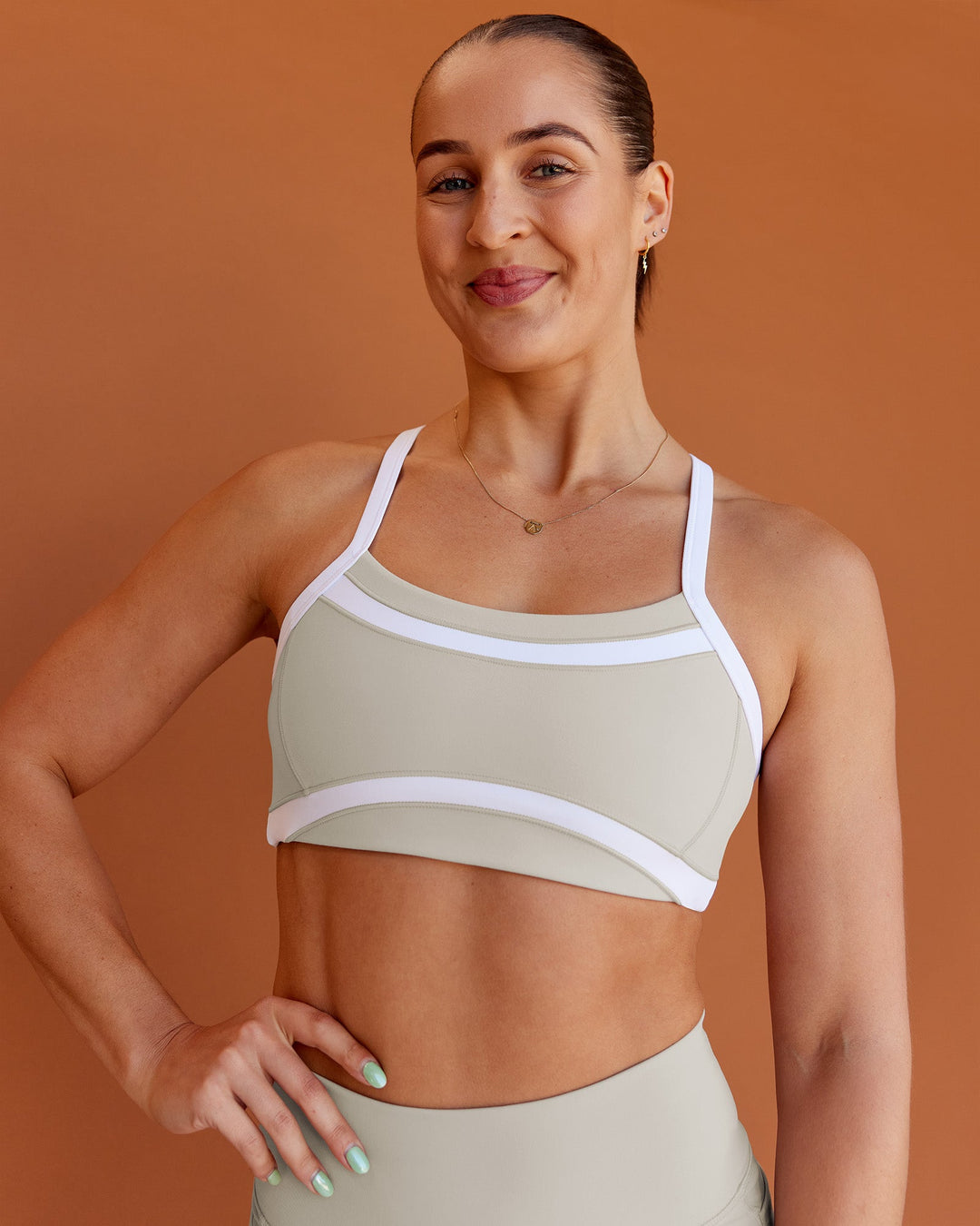 Woman wearing Abs Ignite Sports Bra - Shale Beige-White | Model:Abbey | Size:M