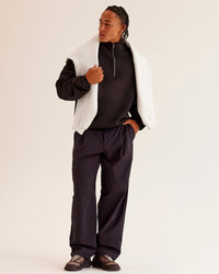Man wearing AfterDark ZeroCrease Quarter Zip - Black | Model:Malebo | Size:M