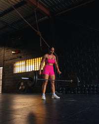 Woman wearing Fusion High-Rise 4" Short Pockets - Ultra Pink | Model:Tiare | Size:M