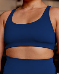 Woman wearing Impulse Reversible Sports Bra - Midnight Blue | Model:Vana | Size:M | Thumbnail Index: 1