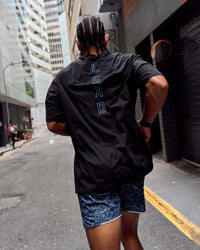 Man wearing Run Club Script FLXCotton Oversized Tee - Black-Palace Blue | Model:Malebo | Size:M
