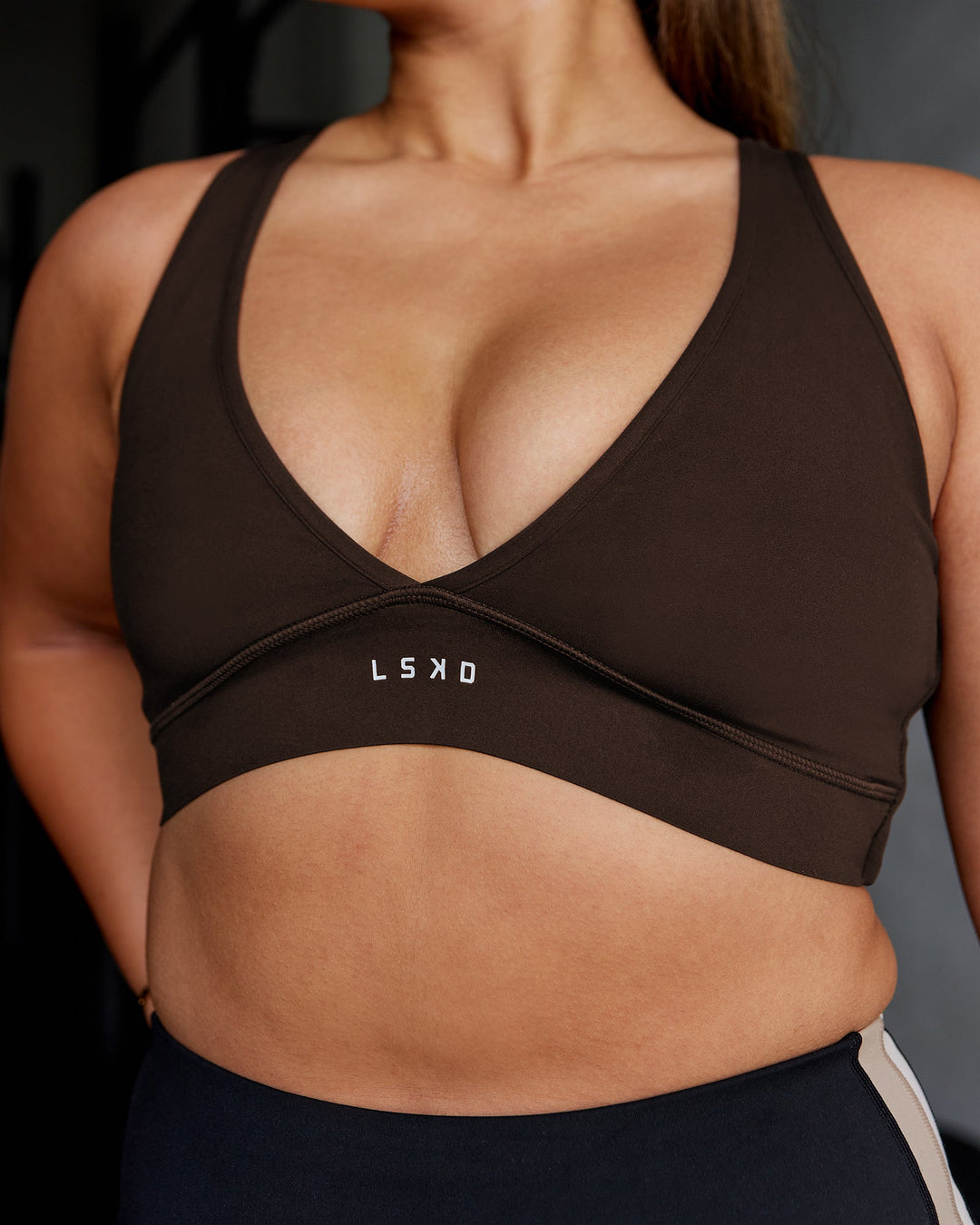 Woman wearing Stamina Sports Bra - Dark Walnut | Model:Gloria | Size:M