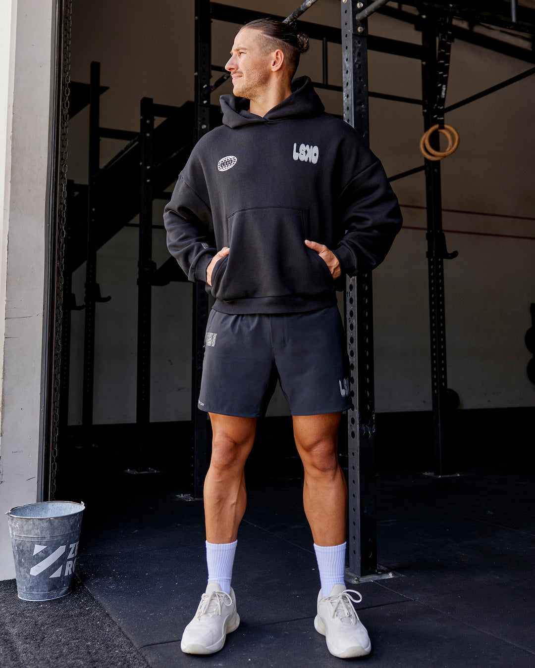 Man wearing Static Grit Unisex Boxy Hoodie - Black-Alloy | Model:Jaiden | Size:M