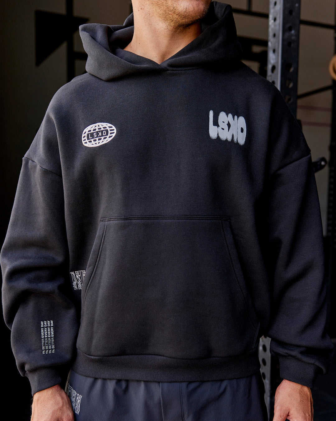 Man wearing Static Grit Unisex Boxy Hoodie - Black-Alloy | Model:Jaiden | Size:M
