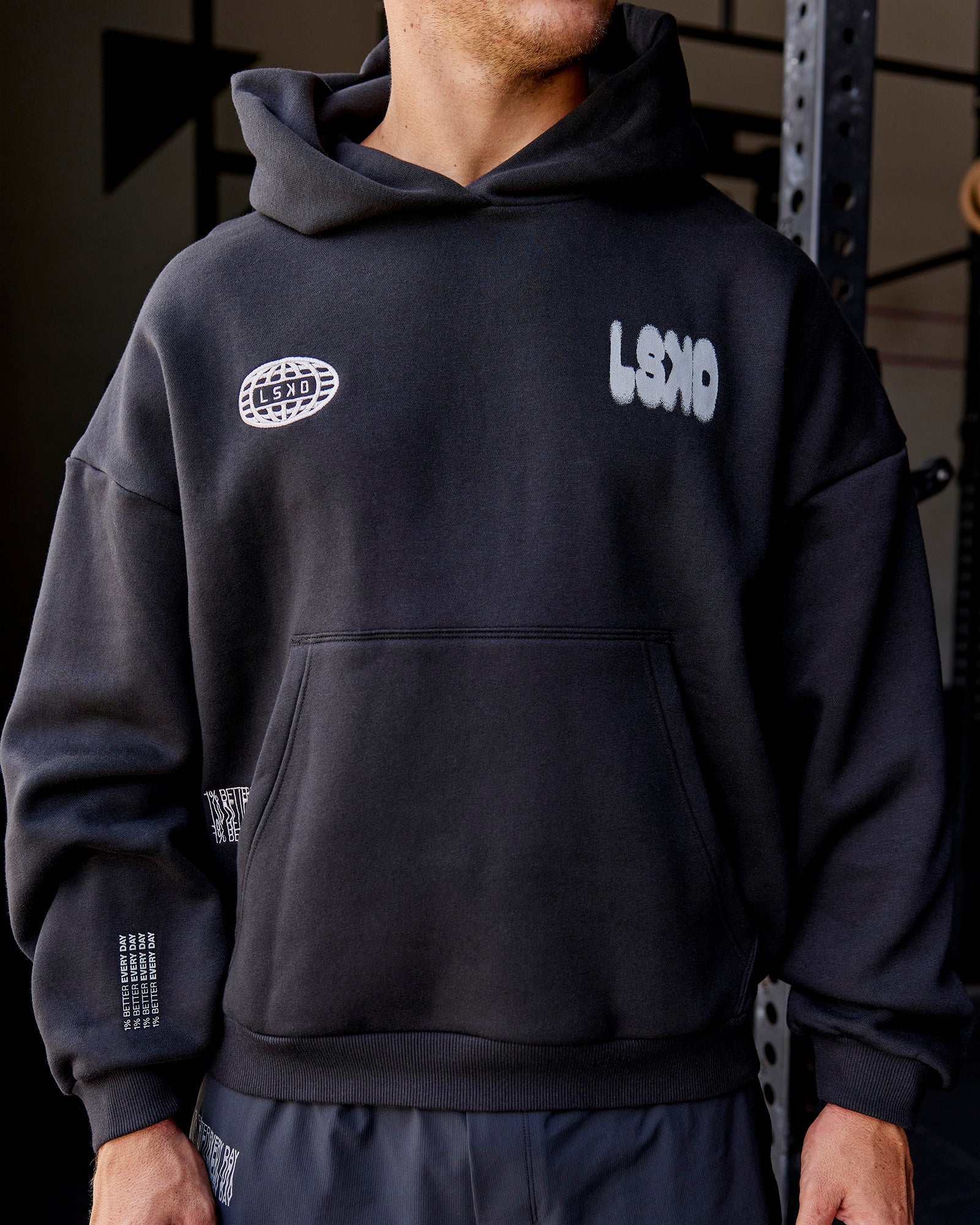 Man wearing Static Grit Unisex Boxy Hoodie - Black-Alloy | Model:Jaiden | Size:M