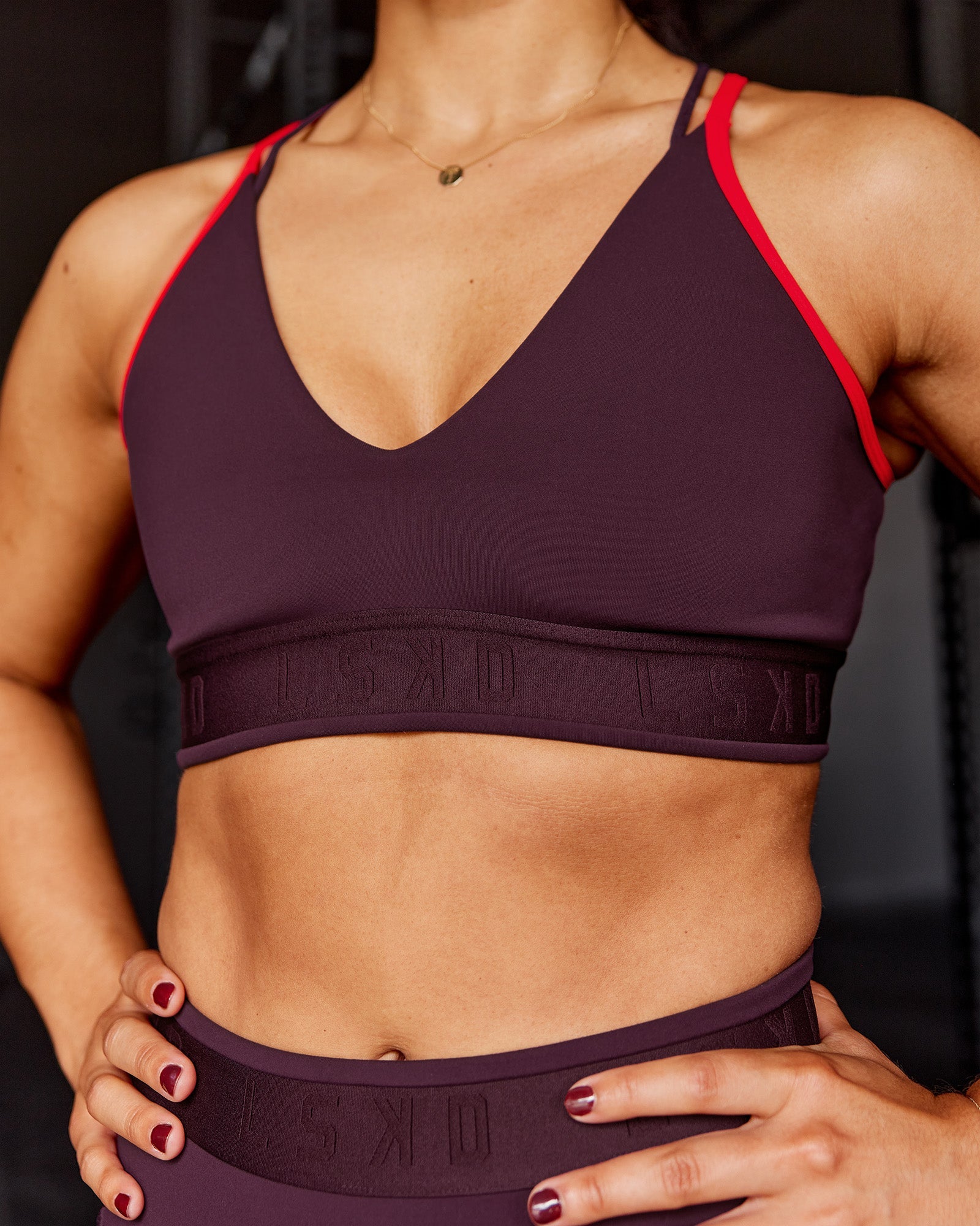 Woman wearing Strive Jacquard Sports Bra - Cherry Lacquer | Model:Tyra | Size:M