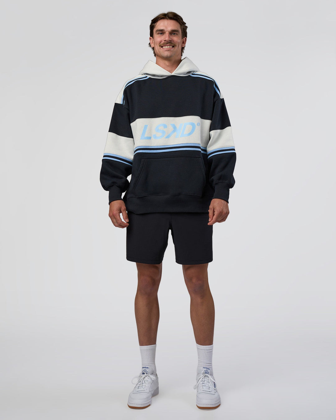 Man wearing A-Team Oversized Hoodie - Caviar-Open Air | Model:Konnor | Size:M