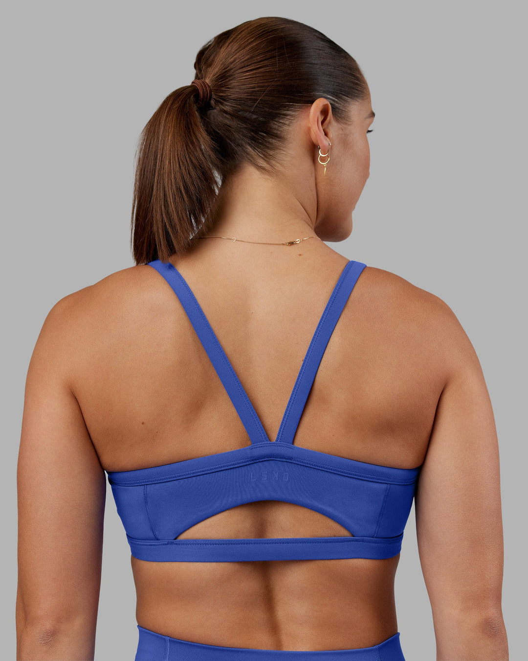 Woman wearing Abs Ignite Sports Bra - Power Cobalt | Model:Abbey | Size:M