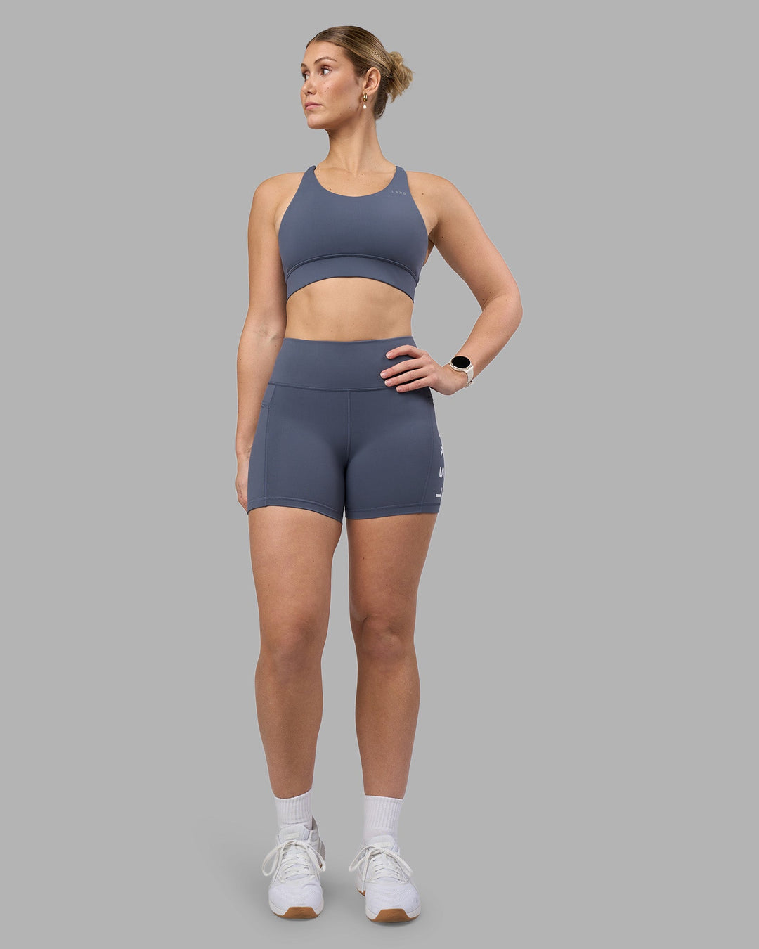 Woman wearing Accelerate Sports Bra - Night Shadow | Model:Amy | Size:M
