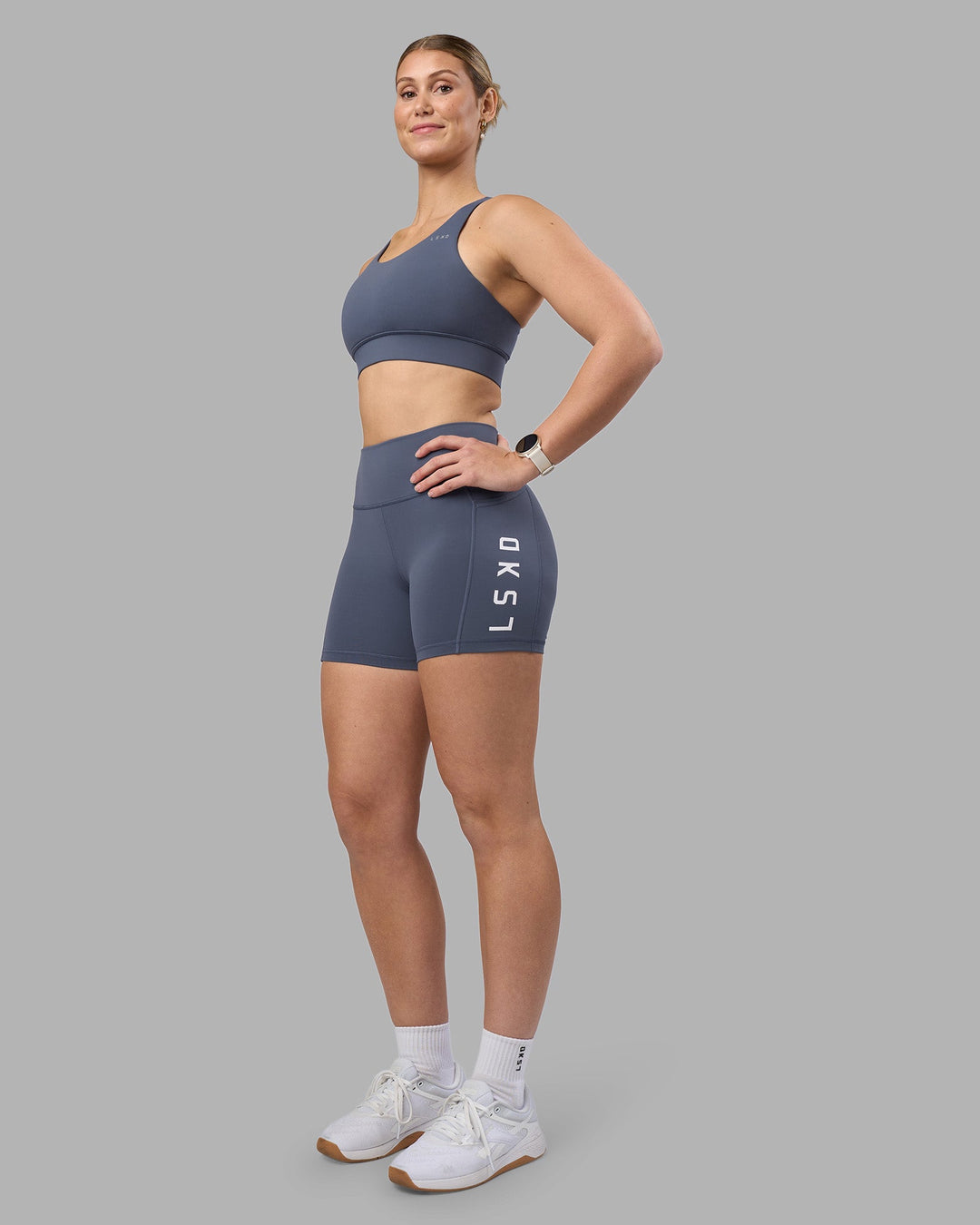Woman wearing Accelerate Sports Bra - Night Shadow | Model:Amy | Size:M