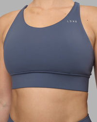 Woman wearing Accelerate Sports Bra - Night Shadow | Set:true | Angle:closeup | Model:Amy | Size:M