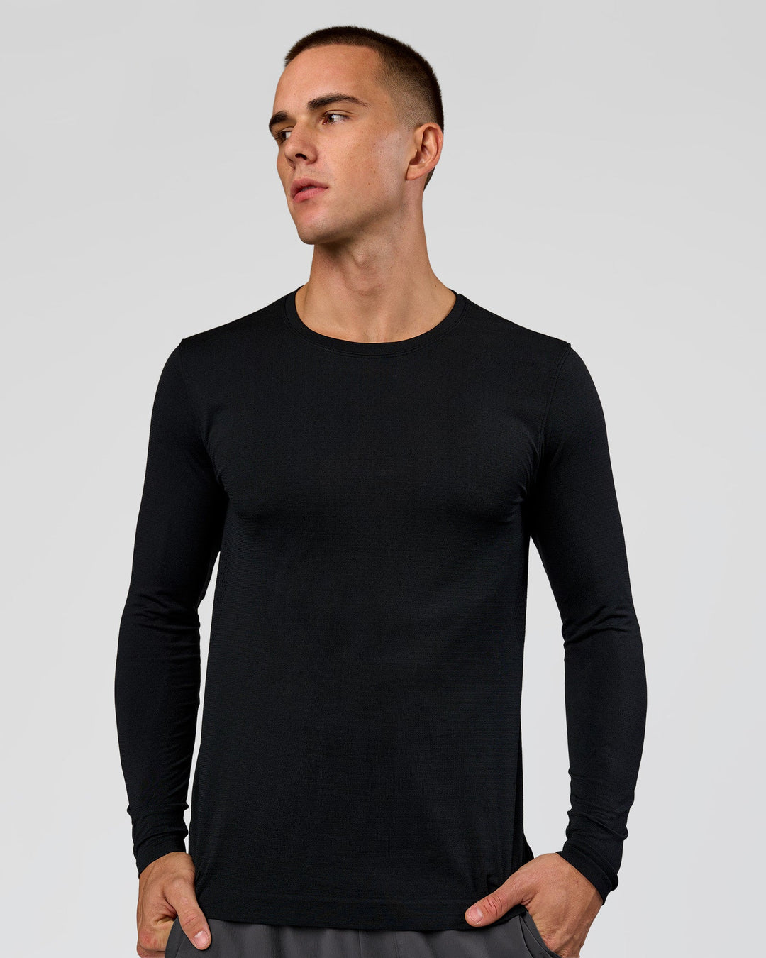 Man wearing AeroFLX+ Seamless Long Sleeve Tee (Set in Sleeve) in Black/Black | Model:Albert | Size:M - view 1