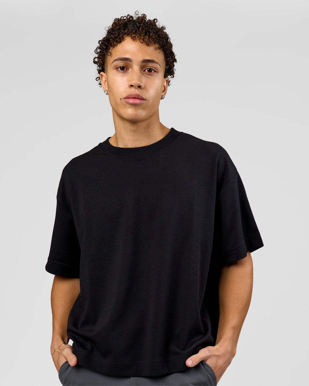 Man wearing AfterDark ZeroCrease Boxy Tee in Black | Model:Leandro | Size:M