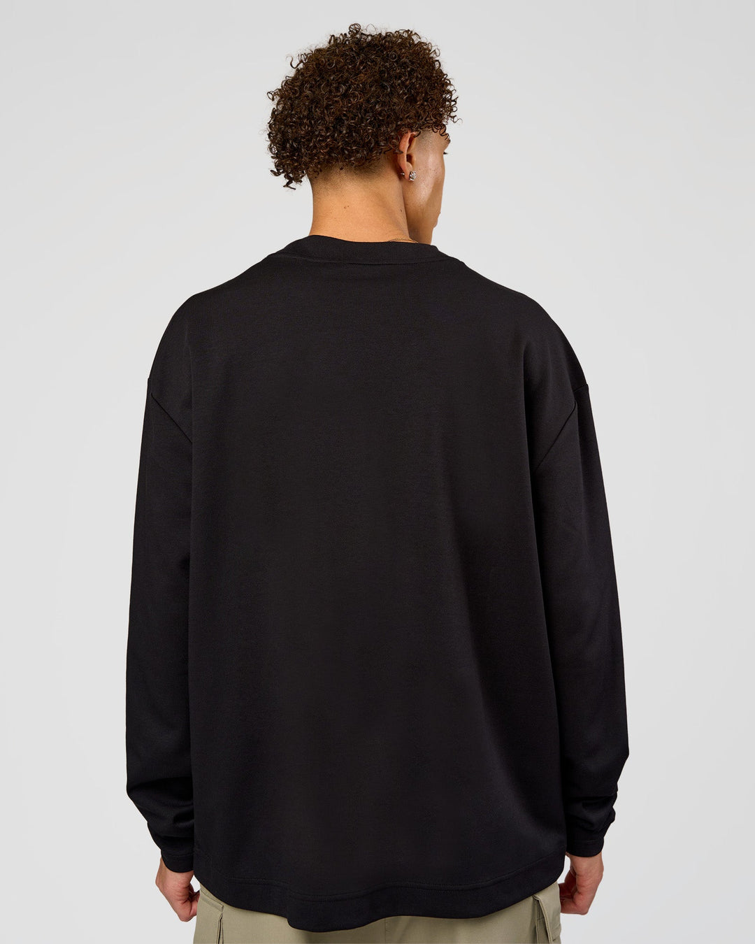 Man wearing AfterDark ZeroCrease Long Sleeve Tee - Black | Model:Leandro | Size:M