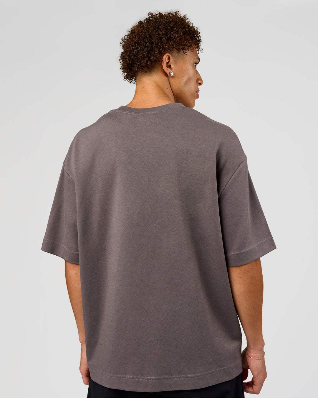 Man wearing AfterDark ZeroCrease Oversized Tee - Duskstone | Model:Leandro | Size:M
