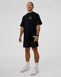 Man wearing Archive FLXCotton Oversized Tee - Black-Open Air | Model:Jaiden | Size:M