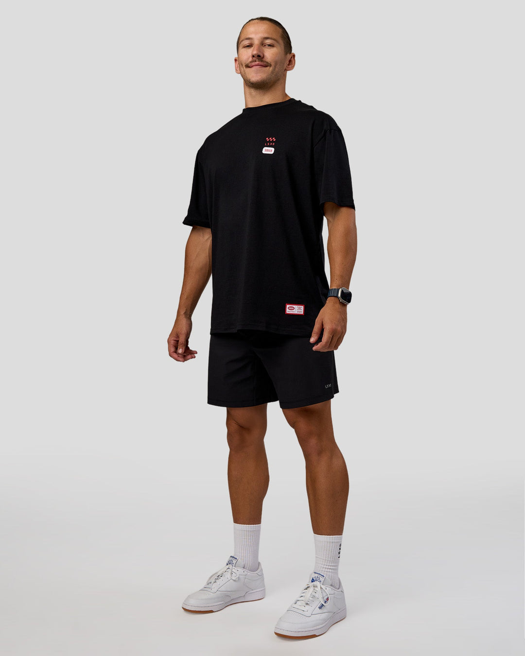 Man wearing Archive FLXCotton Oversized Tee - Black-Scarlet | Model:Jaiden | Size:M