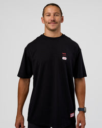 Man wearing Archive FLXCotton Oversized Tee - Black-Scarlet | Model:Jaiden | Size:M