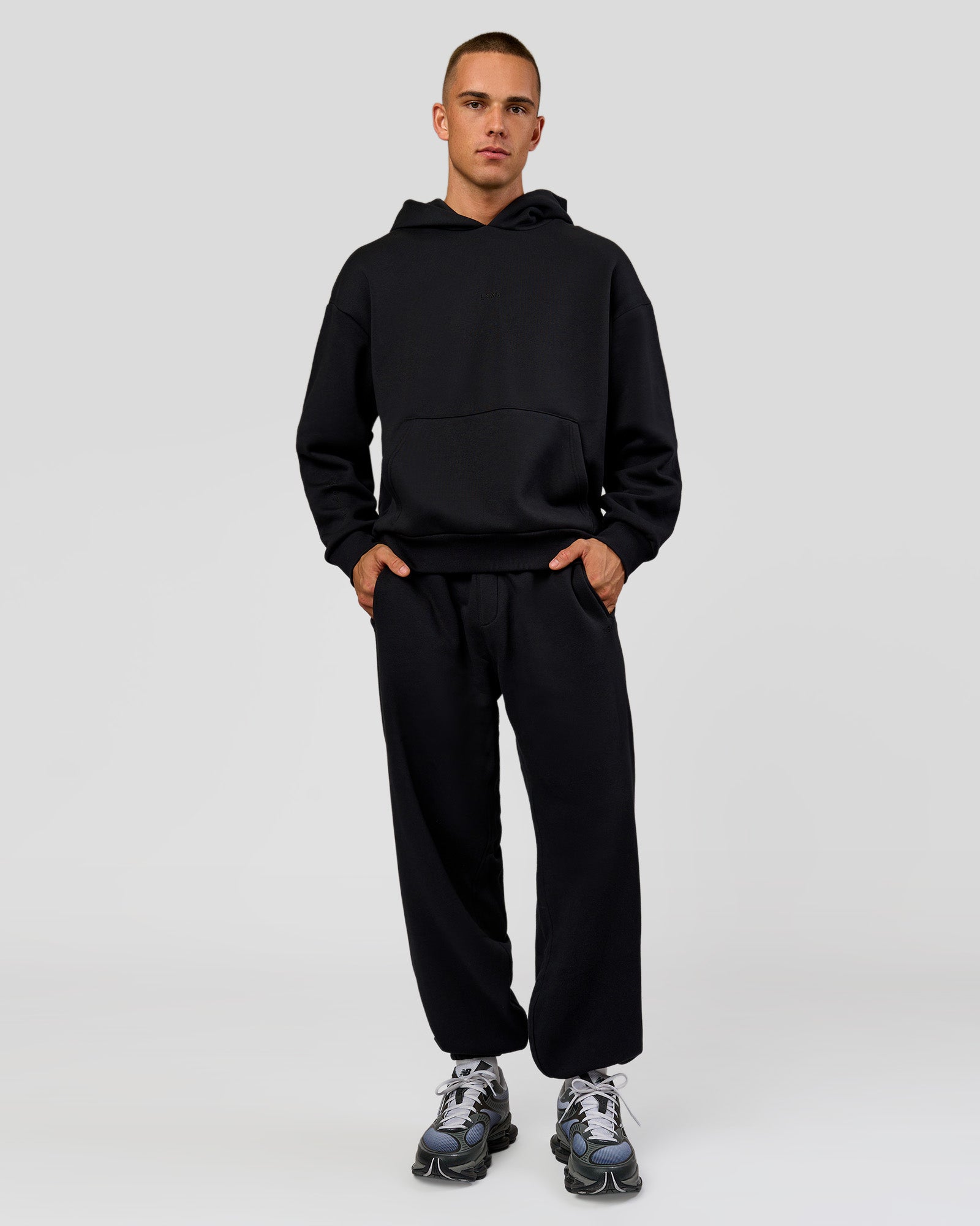 Man wearing Base Baggy Cuffed Track Pant - Black | Model:Albert | Size:M |