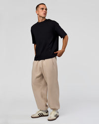 Man wearing Base Baggy Cuffed Track Pant - Shale Beige | Model:Albert | Size:M | | Thumbnail Index: 2