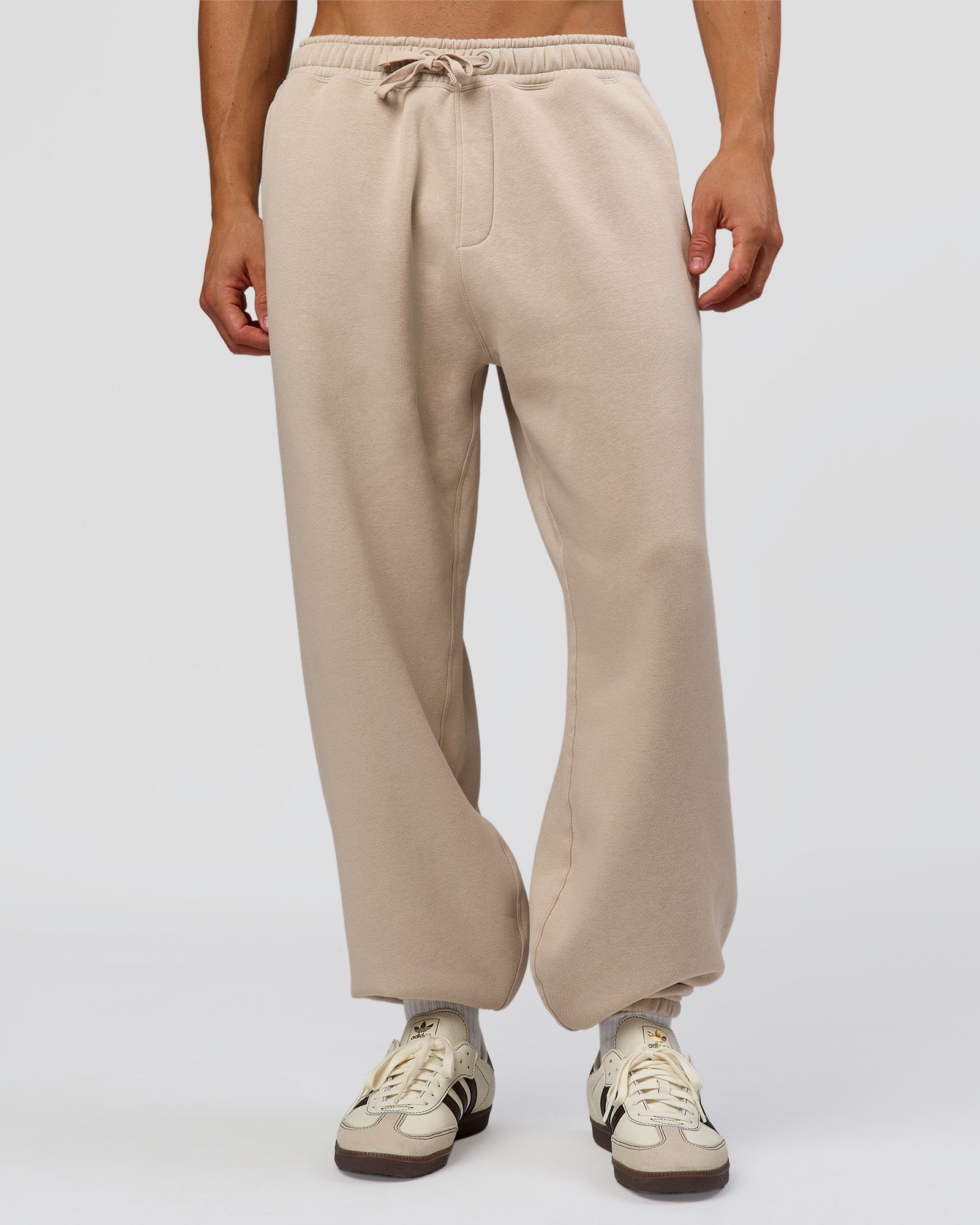 Man wearing Base Baggy Cuffed Track Pant - Shale Beige | Model:Albert | Size:M |