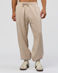 Man wearing Base Baggy Cuffed Track Pant - Shale Beige | Model:Albert | Size:M | | Thumbnail Index: 0