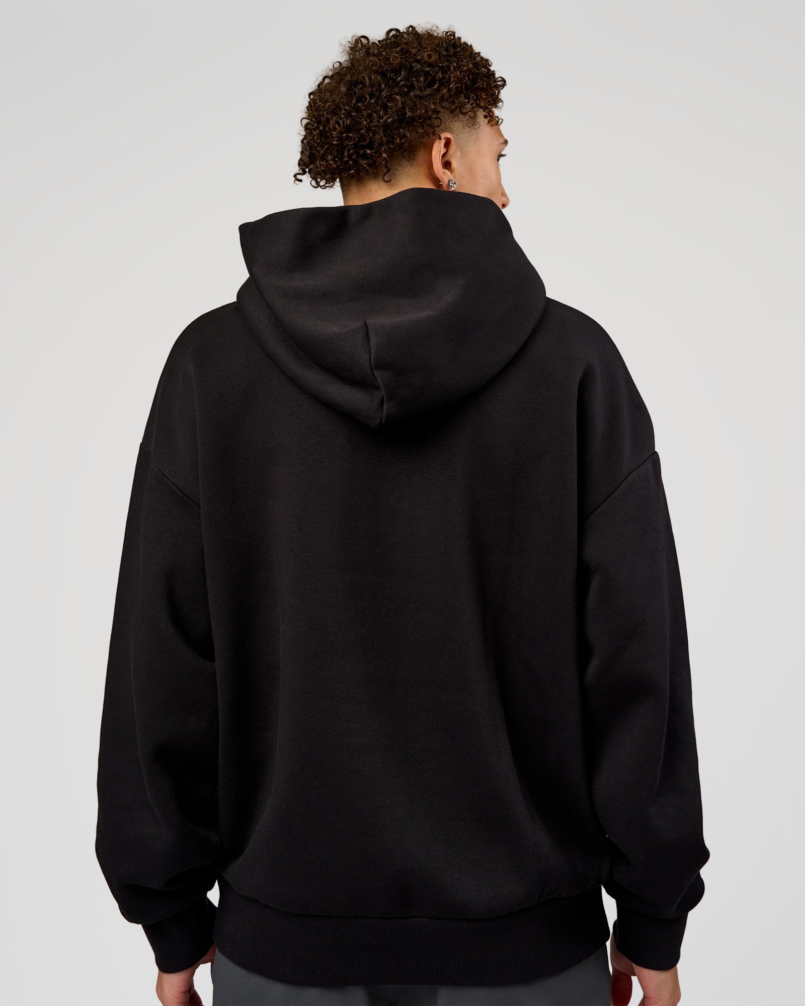 Man wearing Base Oversized Hoodie - Black | Model:Leandro | Size:M |