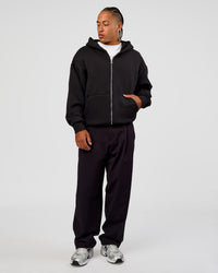 Man wearing Base Zip Through Oversized Hoodie - Black | Model:Malebo | Size:M