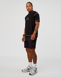 Man wearing CF Unisex Oversized Heavyweight FLXCotton Tee - Black-CF Move Through It | Model:Malebo | Size:M