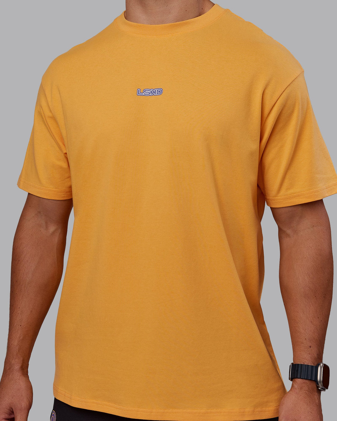 Man wearing CFT BNE 25 FLXCotton Oversized Tee - Warm Apricot-Purple Opulence | Model:Jaiden | Size:M