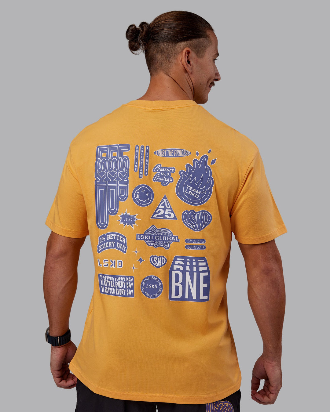 Man wearing CFT BNE 25 FLXCotton Oversized Tee - Warm Apricot-Purple Opulence | Model:Jaiden | Size:M