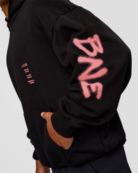 Man wearing CFT BNE 26 Unisex Oversized Hoodie - Black-Candy Pink | Model:Malebo | Size:M