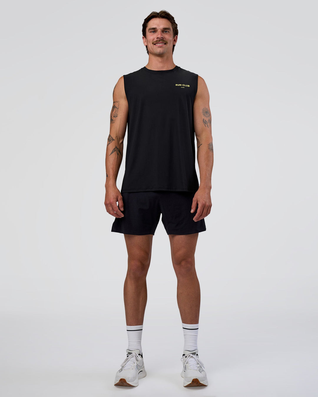 Man wearing Cadence RUN CLUB Muscle Tank - Black-Yellow Fizz | Model:Konnor | Size:M