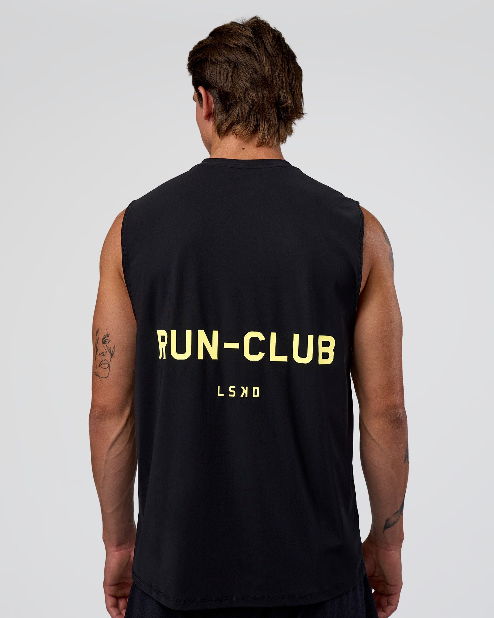 Man wearing Cadence RUN CLUB Muscle Tank - Black-Yellow Fizz | Model:Konnor | Size:M