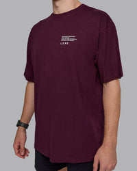 Man wearing Coffee Run FLXCotton Oversized Tee - Cherry Lacquer-Black | Model:Cameron | Size:M