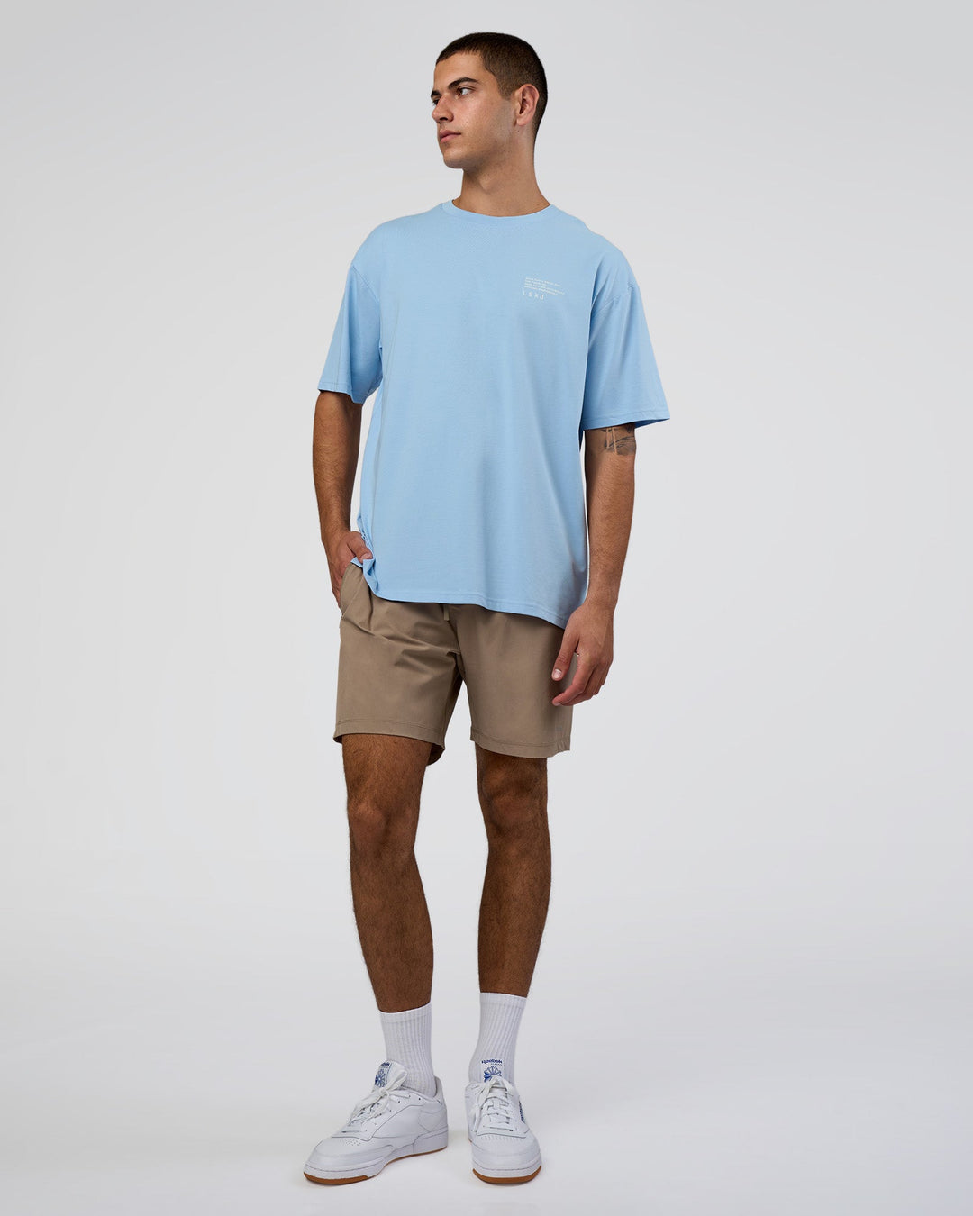 Man wearing Coffee Run FLXCotton Oversized Tee - Open Air-White | Model:Zoran | Size:M