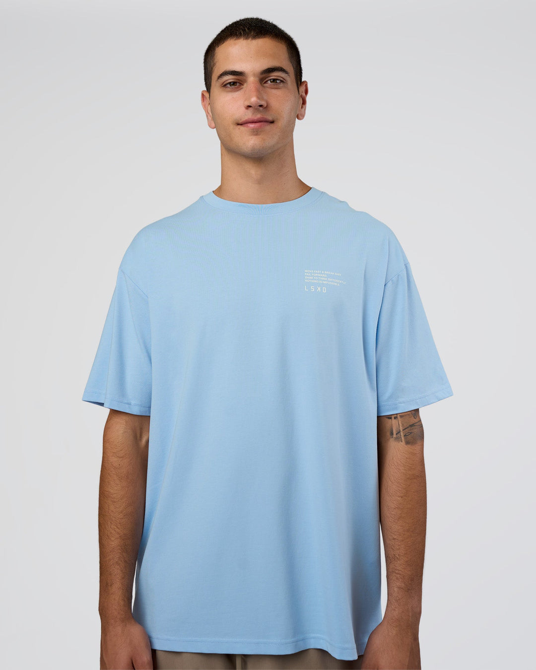 Man wearing Coffee Run FLXCotton Oversized Tee - Open Air-White | Model:Zoran | Size:M