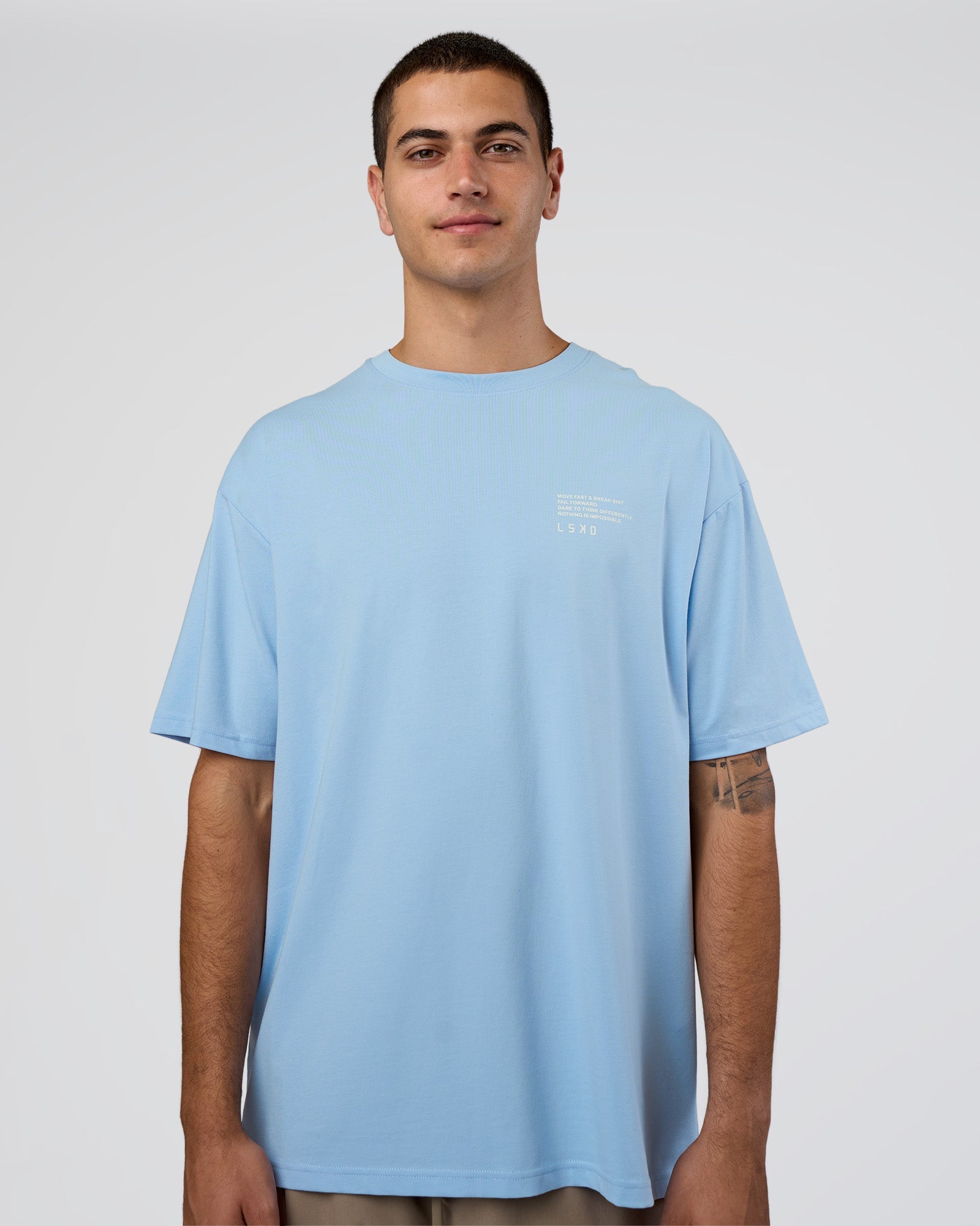 Man wearing Coffee Run FLXCotton Oversized Tee - Open Air-White | Model:Zoran | Size:M